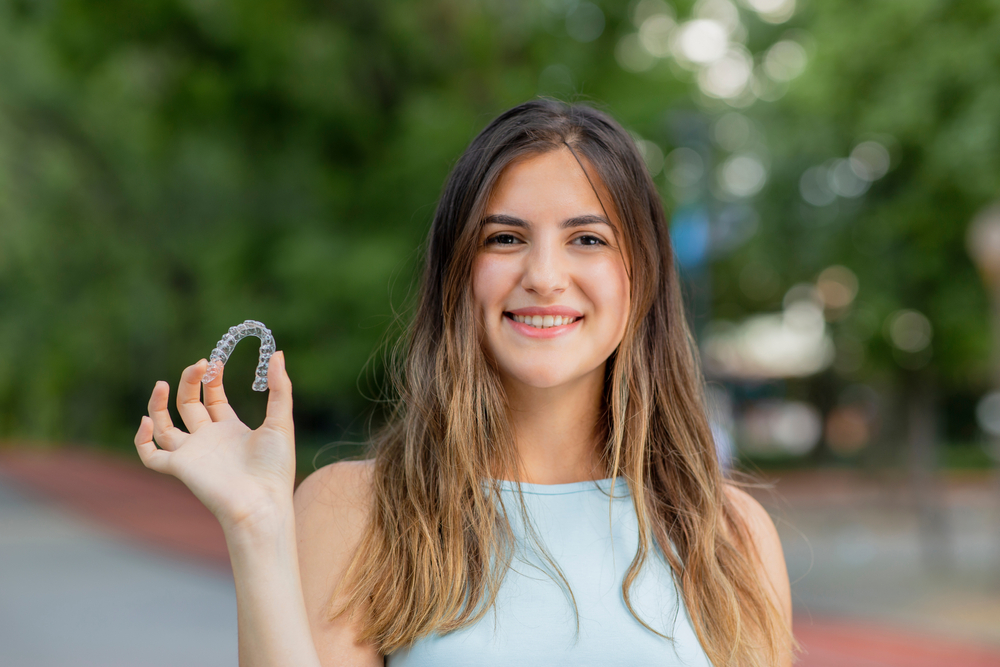 Dental professional examining a patient’s smile during an Invisalign checkup, ensuring precise alignment and comfortable progress – Invisalign in Dripping Springs