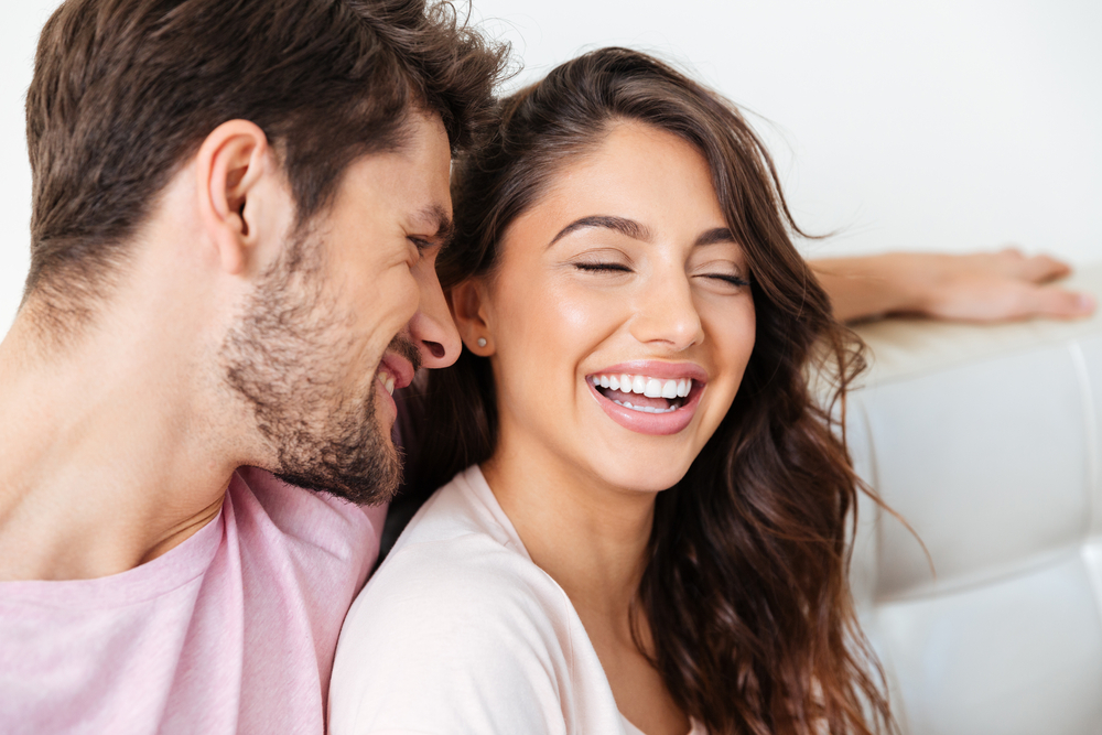 Confident Couple Smiles with Invisalign Results – Invisalign in Austin, Texas Happy couple laughing together, showcasing confident, natural smiles achieved through clear aligner treatment – Invisalign in Austin, Texas