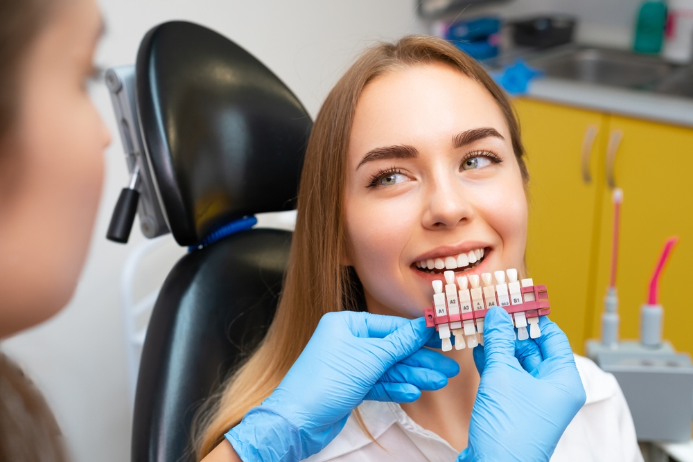 Dentist matching veneer shades to a patient’s natural smile, ensuring precise color selection for beautiful, natural-looking results – Austin TX Veneers