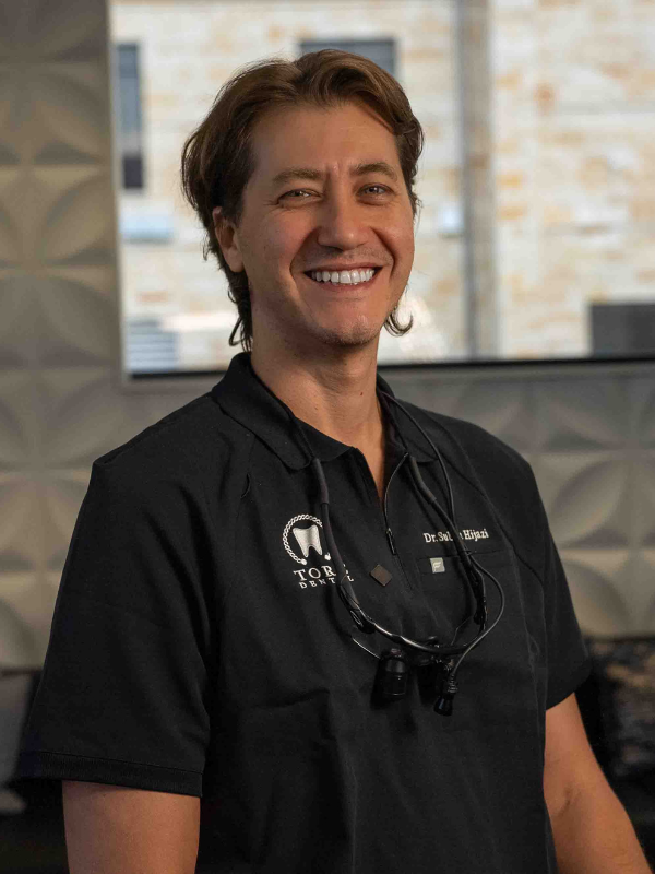 Portrait of the founder, Dr. Saleh Hijazi, smiling and wearing his dental loupes - Dr Hijazi 