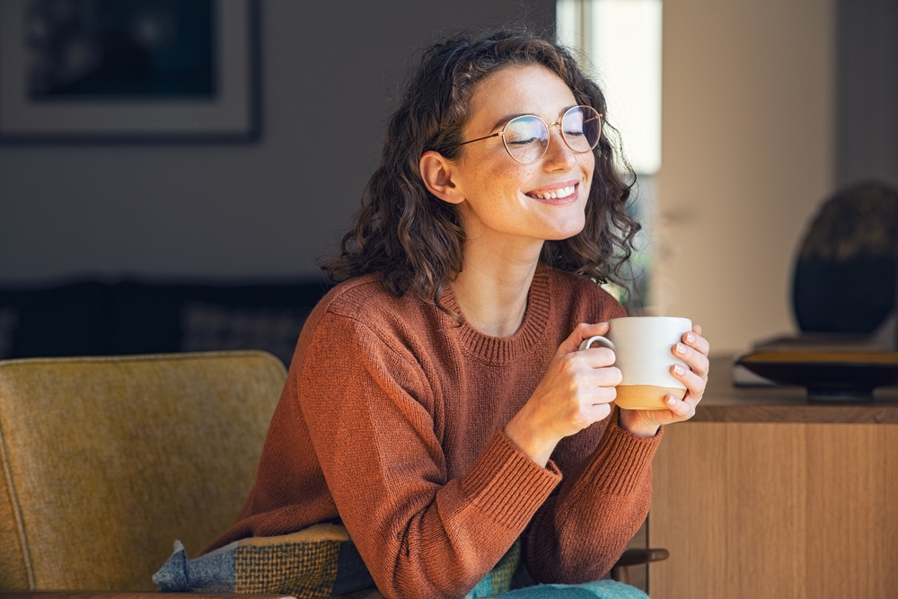 A relaxed, smiling patient enjoying a quiet moment at home, representing confidence, comfort, and lasting oral health after personalized dental care – Wimberly Dentist