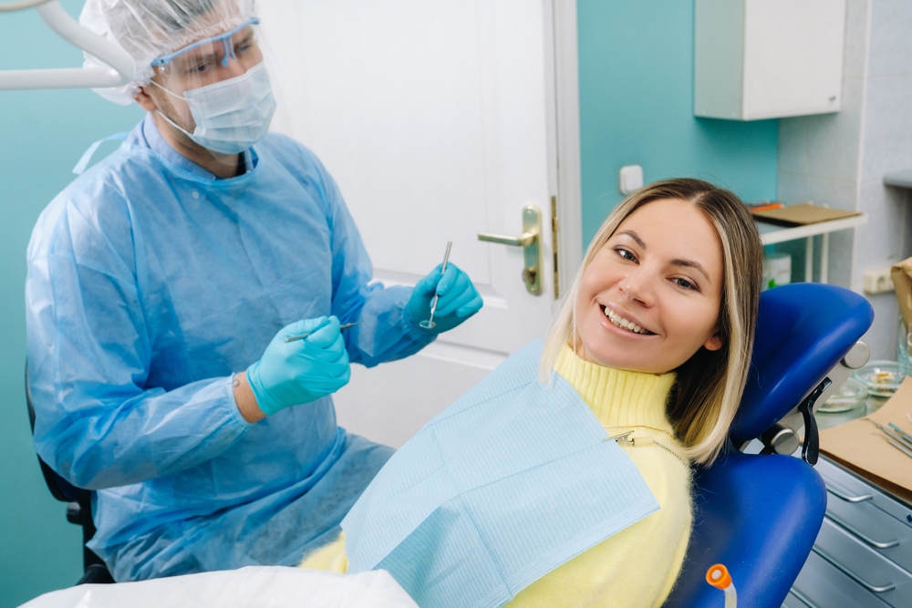 Patient smiling comfortably during a professional teeth cleaning, highlighting gentle care and a relaxed dental experience – Teeth Cleaning in Austin