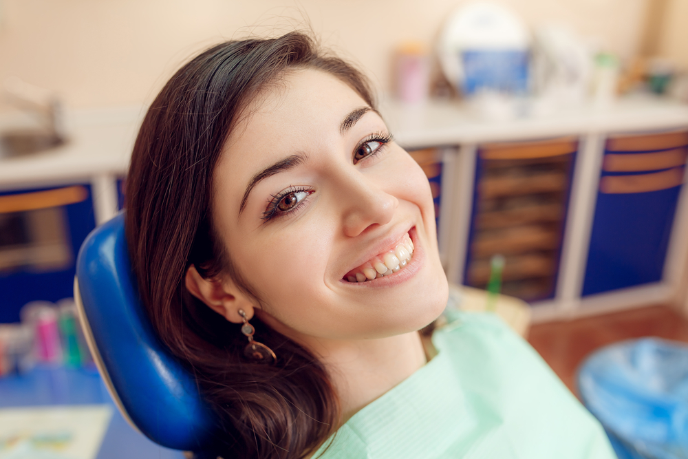 Confident Smile After Dental Implant Care – Austin TX Dental Implants Patient smiling comfortably in a dental chair, showcasing confidence and natural-looking results made possible by dental implants – Austin TX Dental Implants