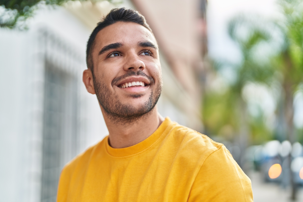 Straight, Confident Smile with Invisalign – Invisalign in Austin, Texas Man smiling confidently outdoors, reflecting the lifestyle-friendly benefits of Invisalign clear aligners – Invisalign in Austin, Texas