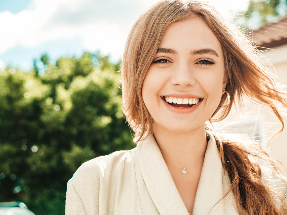 Smiling Patient After a Comfortable Dental Appointment – Comfort Menu A happy patient reflects a smooth, anxiety-free dental visit made possible through thoughtful comfort amenities and personalized care – Comfort Menu