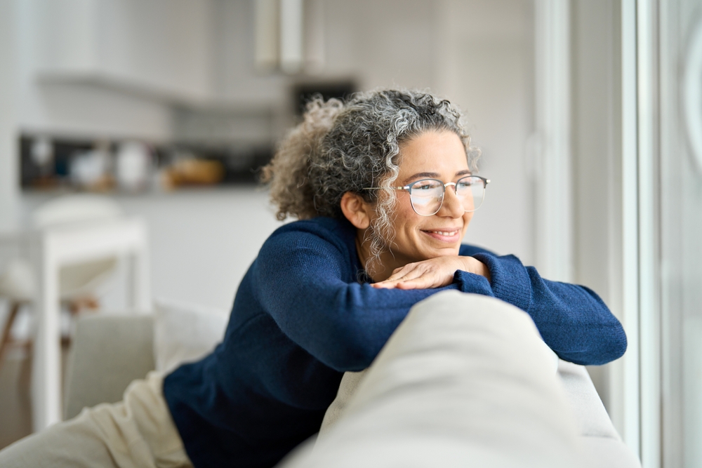 A calm, smiling patient resting at home, representing relief, comfort, and peace of mind after prompt, compassionate emergency dental treatment – Emergency Dentist in Austin