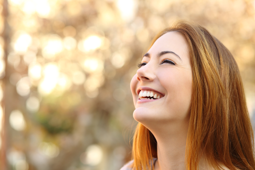 Enjoying Life Pain-Free After Tooth Sensitivity Treatment – Sensitivity Treatment Happy patient enjoys a radiant, pain-free smile outdoors after receiving effective sensitivity treatment for lasting dental comfort – Sensitivity Treatment